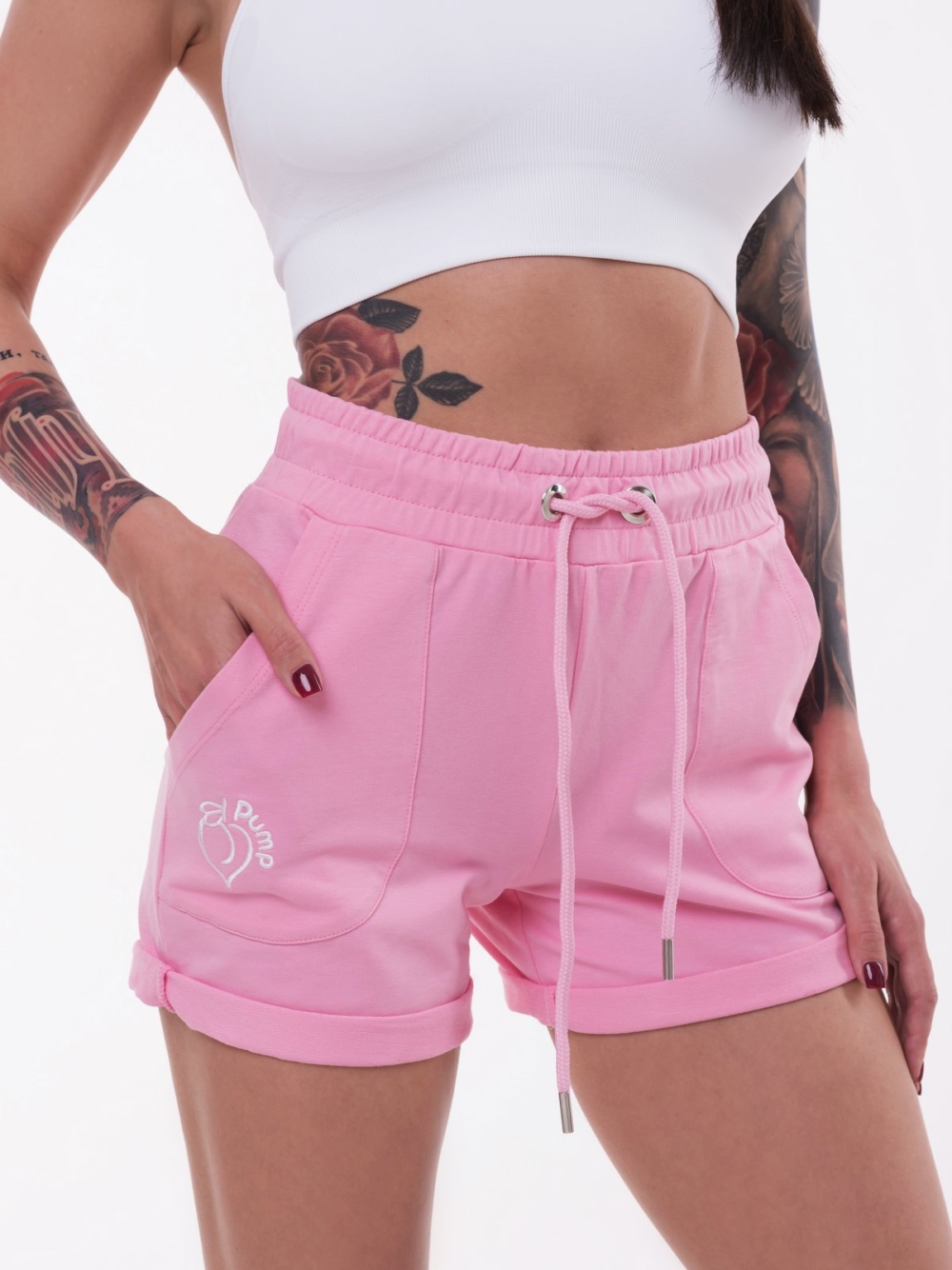 Pink short shorts with white embroidery on the pocket and tightening at the waist
