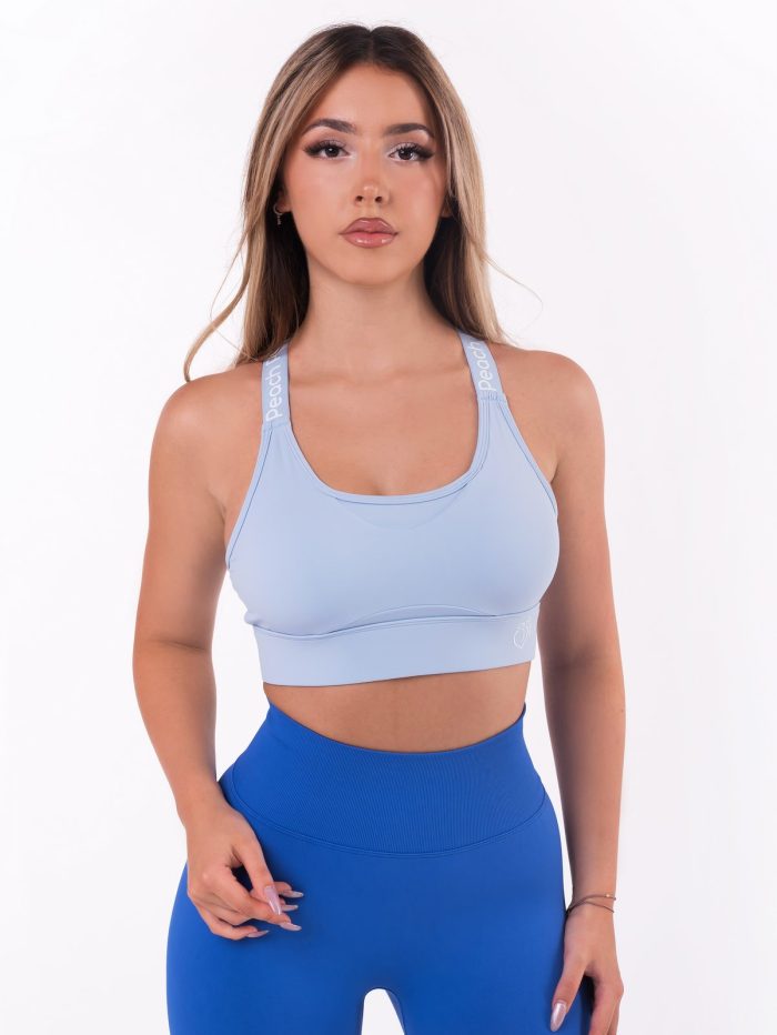 Baby blue sports bra with push-up pads and lettering on the crossed straps