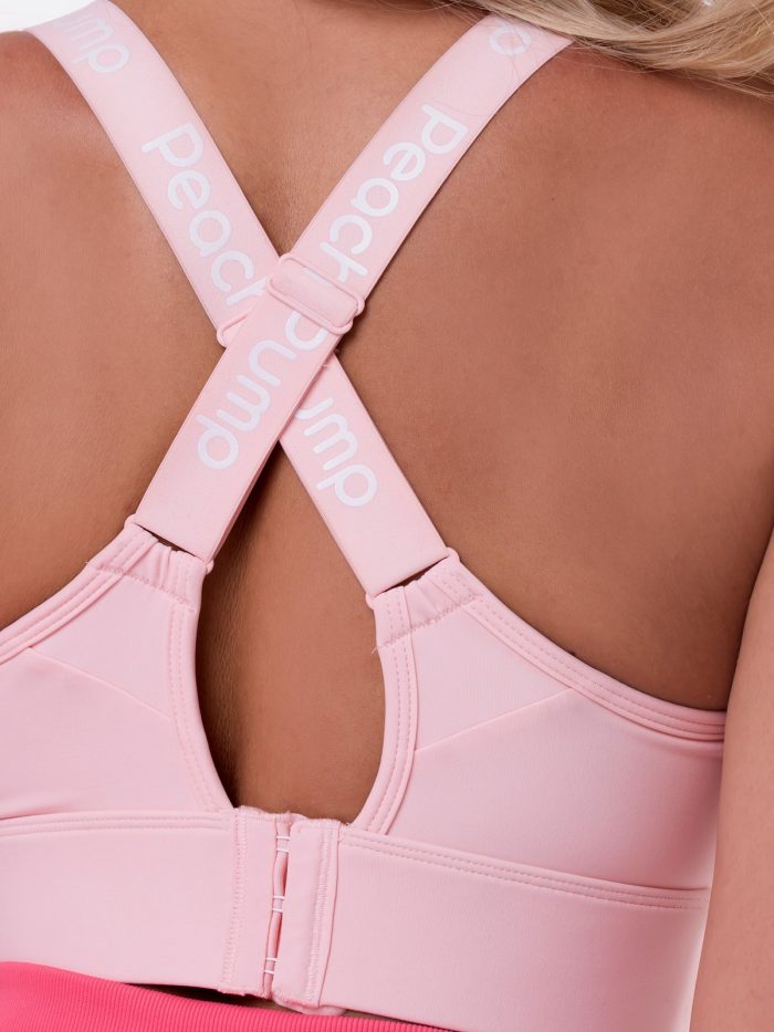 Photo of cross straps, pink Peach Pump sports bra with multi-level fastening