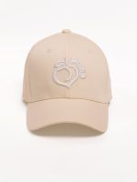 Beige baseball cap with visor and white embroidered Peach Pump logo