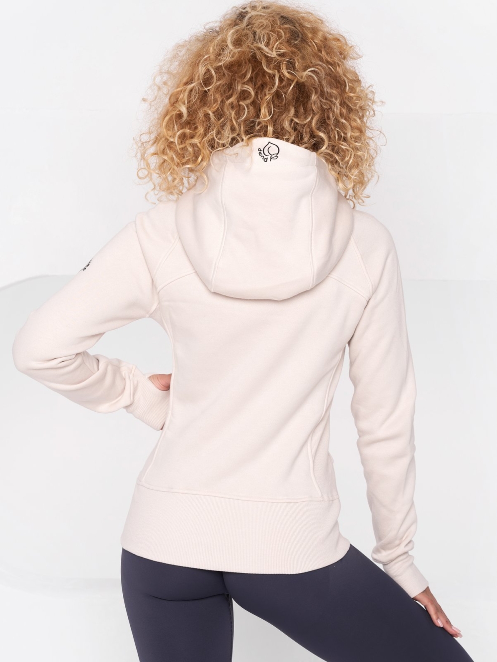 Controversial beige sweatshirt-style hoodie with zipper and large Peach Pump logo hood.