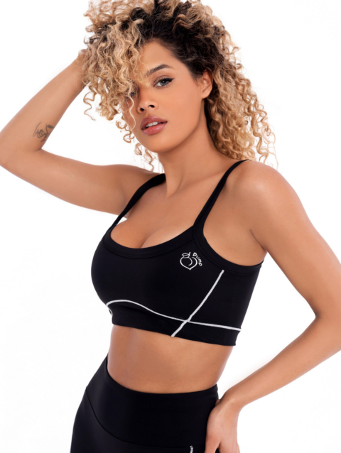 Black sports bra with white lines, black straps and padding by Peach Pump