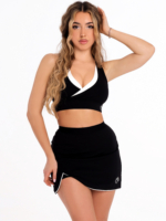 Black sports skirt with white trim at the hem and short built-in shorts with side pockets