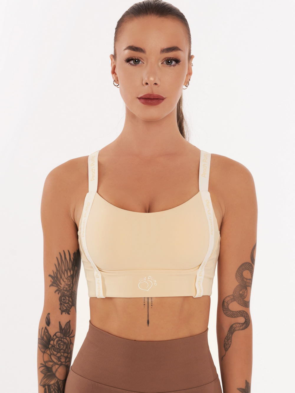 Beige sports bra with Peach Pump prints along the length