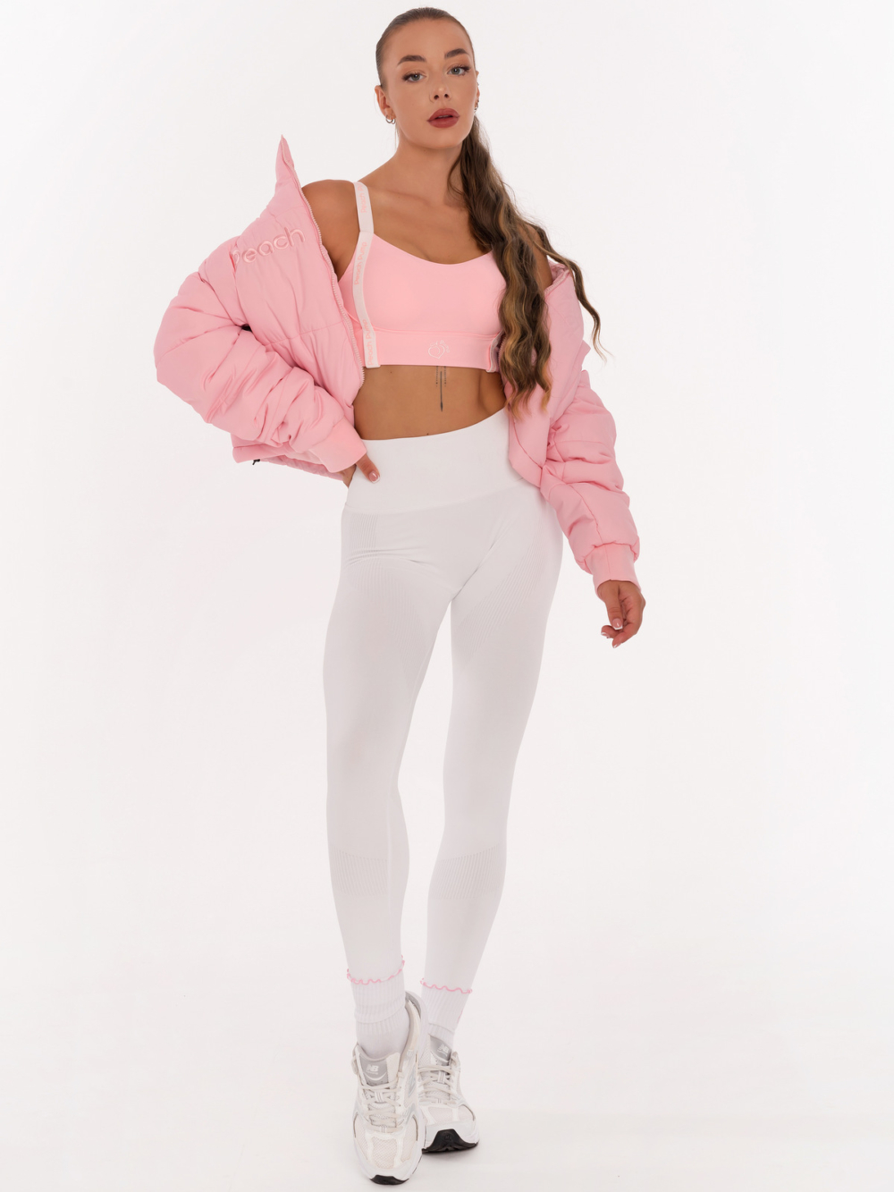 Striking pink sports bra with Peach Pump lettering