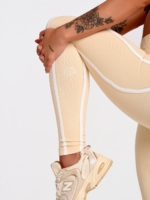 Women's full-length beige leggings with a sculpting, high-compression fit.